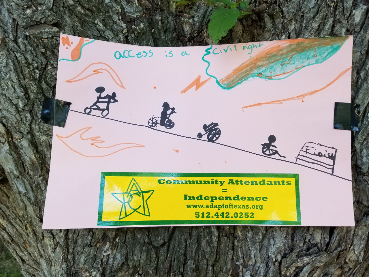 Kid’s drawing of a line of people in various kinds of wheelchairs and scooters.  Above the slogan Access is a Civil Right.  Below a Community Attendants bumper sticker.